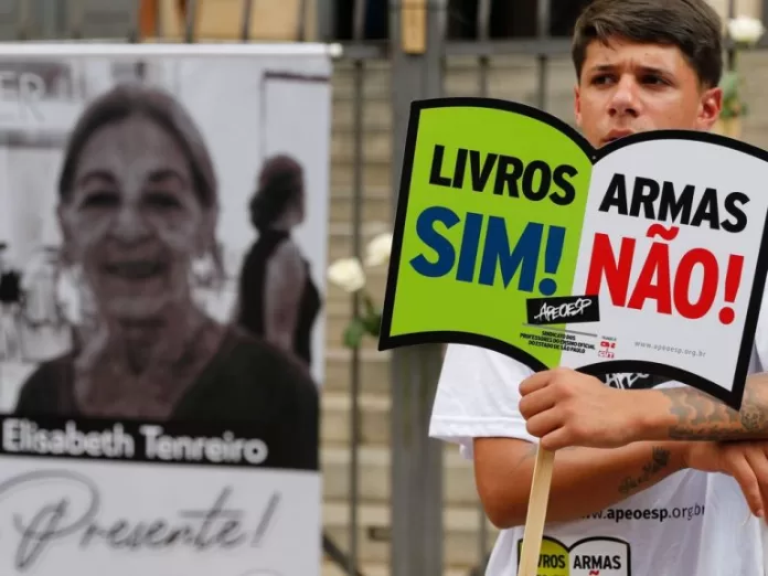 Menino segura um cartaz escrito: Livros sim. Armas não