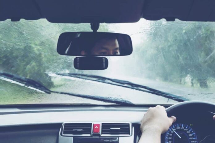 Man driving car in heavy rainfall